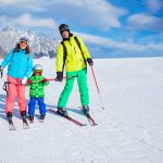 Ski, winter, snow, skiers, sun and fun - family enjoying winter vacations.
